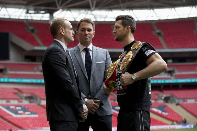 IBF and WBA super-middleweight boxing champion Carl Froch, right, poses for photographers in a head-to-head with his opponent George Groves, left, and British boxing promoter Eddie Hearn at Wembley Stadium in London, Thursday, May 29, 2014.  Billed as one of the biggest fights in British boxing history, the second installment of Carl Froch vs. George Groves has the ingredients of a classic. Saturday's fight for Froch's IBF and WBA super-middleweight titles will take place at Wembley Stadium in front of a record British boxing crowd of about 80,000 fans.  (AP Photo/Matt Dunham)