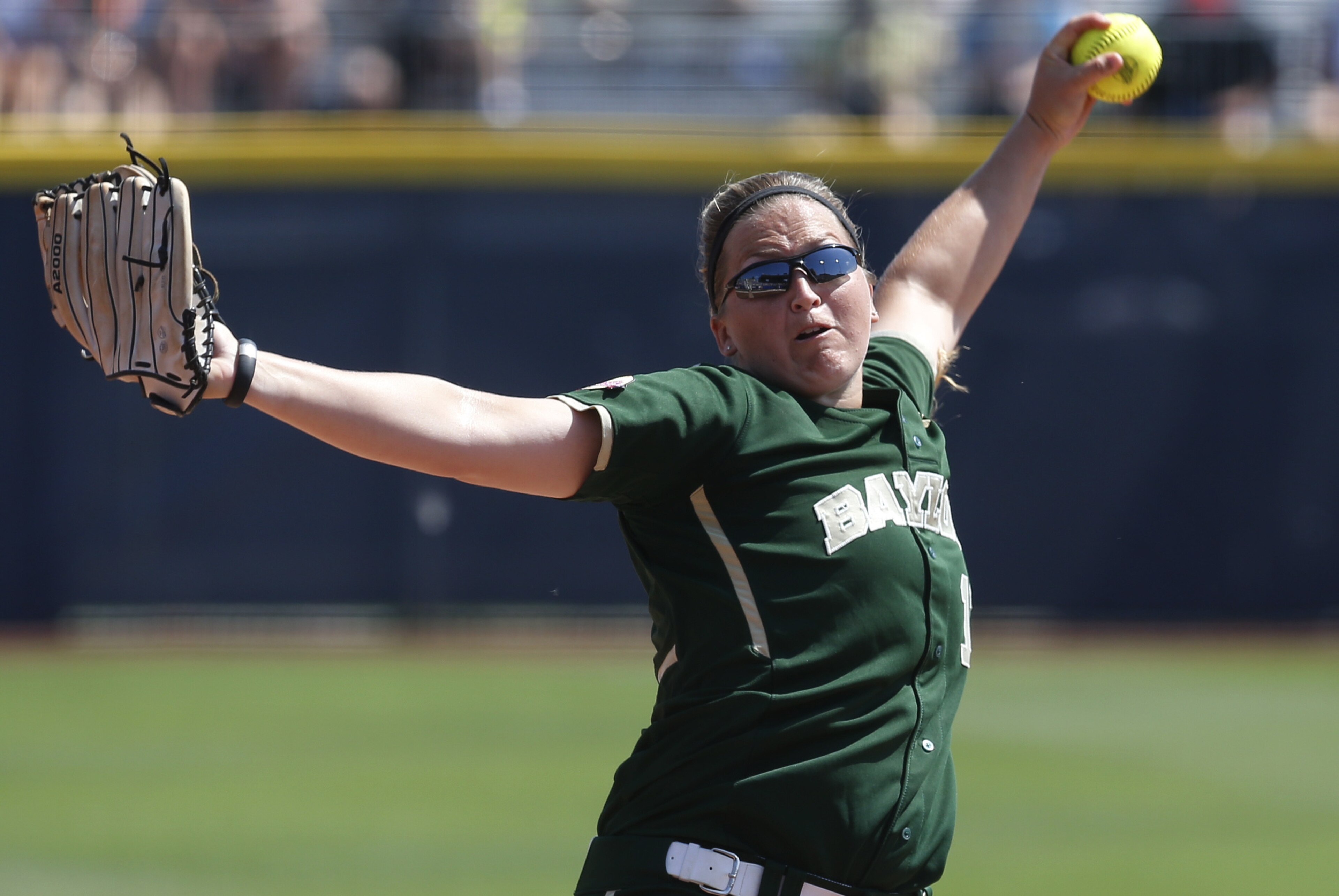Baylor's Whitney Canion (11) pitches against Florida in the first inning of an NCAA Women's College World Series softball tournament game in Oklahoma City, Thursday, May 29, 2014. (AP Photo/Sue Ogrocki)