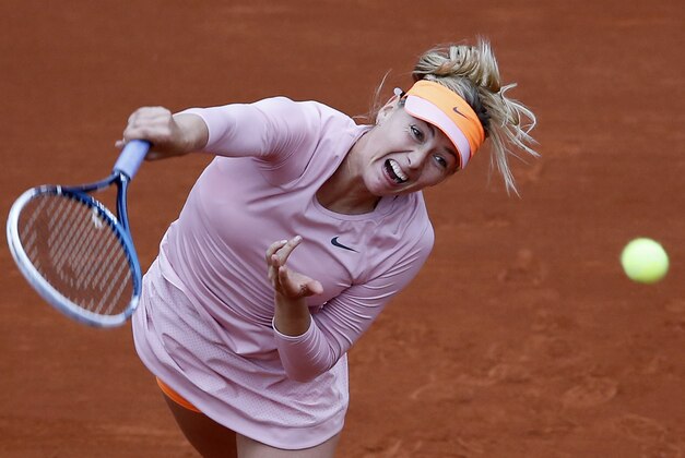 Russia's Maria Sharapova returns the ball to  Bulgaria's Tsvetana Pironkova during the second round match of  the French Open tennis tournament at the Roland Garros stadium, in Paris, France, Wednesday, May 28, 2014. (AP Photo/David Vincent)