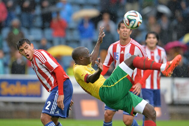 Cameroon's Vincent Aboubakar, foreground,  in action during their friendly soccer match against Paraquay,  in Kufstein, Austrian province of Tyrol, Thursday, May 29,  2014. (AP Photo/Kerstin Joensson)