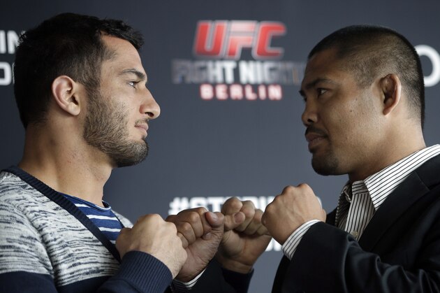 Dutch middleweight fighter Gegard Mousasi, left, and Mark Munoz from the US, right, pose for the photographers prior to a joint press conference in Berlin, Germany, Thursday, April 3, 2014. Munoz and Mousasi will fight during a UFC (Ultimate Fighting Championship) fight night in Berlin on Saturday, May 31, 2014. (AP Photo/Michael Sohn)