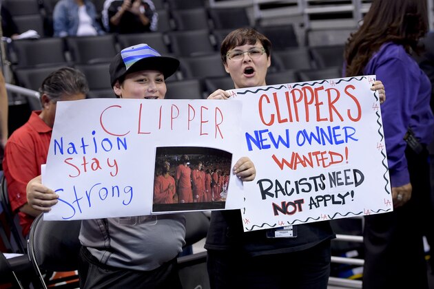 Fans hold up signs in support of the Los Angeles Clippers before Game 5 of an opening-round NBA basketball playoff series between the Clippers and the Golden State Warriors on Tuesday, April 29, 2014, in Los Angeles. NBA Commissioner Adam Silver announced Tuesday that Clippers owner Donald Sterling has been banned for life by the league. (AP Photo)