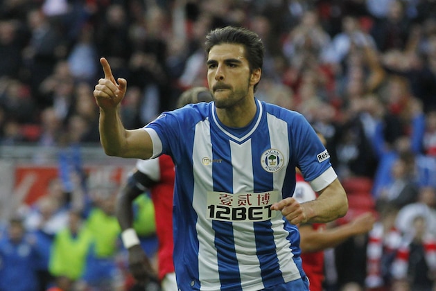 Wigan Athletic's Jordi Gomez celebrates his penalty goal against Arsenal during their English FA Cup semifinal soccer match at Wembley Stadium in London, Saturday, April 12, 2014. (AP Photo/Sang Tan)