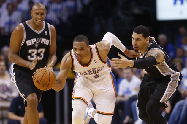 Oklahoma City Thunder guard Russell Westbrook (0) heads up the court after stealing the ball from San Antonio Spurs guard Danny Green (4) in the second quarter of Game 4 of the Western Conference finals NBA basketball playoff series in Oklahoma City, Tuesday, May 27, 2014.  (AP Photo/Sue Ogrocki)