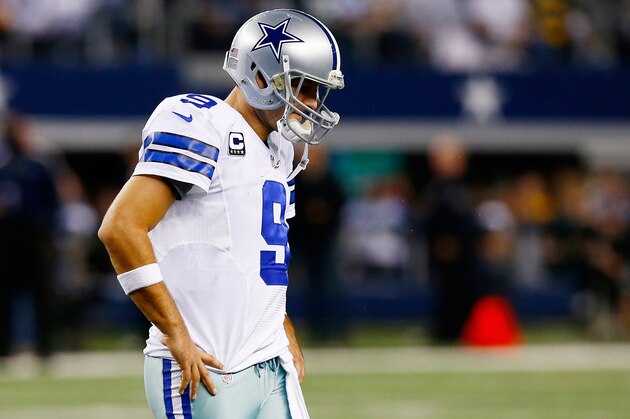 ARLINGTON, TX - DECEMBER 15:  Quarterback Tony Romo #9 of the Dallas Cowboys walks off the field after losing 37-36 to the Green Bay Packers during a game at AT&T Stadium on December 15, 2013 in Arlington, Texas.  (Photo by Tom Pennington/Getty Images)