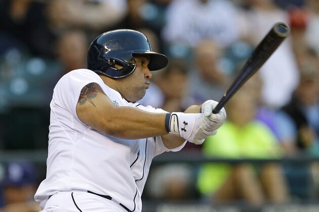 Seattle Mariners Kendrys Morales hits a solo home run in the third inning of a baseball game against the Tampa Bay Rays, Saturday, Sept. 7, 2013, in Seattle. (AP Photo/Ted S. Warren)