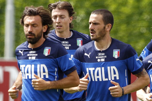 From left, Italy's Andrea Pirlo, Riccardo Montolivo and Ciro Immobile jog during a team training session at Coverciano training grounds, in Florence, Monday, May 26, 2014. In Brazil, Italy is in Group D with England, Uruguay and Costa Rica. (AP Photo/Fabrizio Giovannozzi)