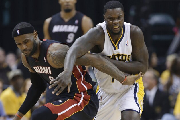 Indiana Pacers guard Lance Stephenson (1) and Miami Heat forward LeBron James (6) scramble for a loose ball during the second half of Game 5 of the NBA basketball Eastern Conference finals in Indianapolis, Wednesday, May 28, 2014. (AP Photo/Michael Conroy)