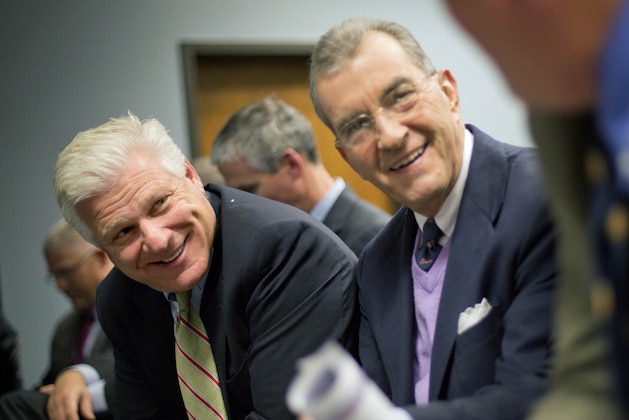 FILE- In this Nov. 26, 2013 file photo, Frank Wren, Atlanta Braves general manager,  left, and John Schuerholz, Braves president, talk with Mike Plant, right, executive vice president of business operations before the start of a Cobb County commission hearing on a proposed plan to build the team a new baseball stadium in the county in Marietta, Ga. The Atlanta Braves pulled perhaps the most surprising move of the year. No, they didn’t win a playoff series. They just announced after months of secret talks with Cobb County leaders plans to move to a suburban stadium and leave downtown where they’ve played since moving from Milwaukee in 1966. The impending Braves’ departure aside, Atlanta Mayor Kasim Reed managed to keep the NFL’s Atlanta Falcons happy. He agreed for the city to cover part of the construction costs for a new retractable-roof stadium to replace the Georgia Dome downtown. Both new stadiums are projected to open in 2017. (AP Photo/David Goldman, File)