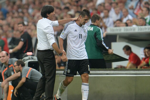 Germany's head coach Joachim Loew, left, comforts Miroslav Klose during the FIFA World Cup 2014 qualification group C soccer match between Germany and Austria in Munich, southern Germany, on Friday, Sept.6, 2013. (AP Photo/ Kerstin Joensson)