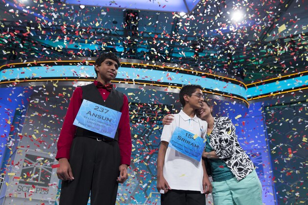 Ansun Sujoe, 13, of Fort Worth, Texas, left, and Sriram Hathwar, 14, of Painted Post, N.Y., celebrate as they wait for the rest of their families to join them on stage after being named co-champions of the National Spelling Bee, on Thursday, May 29, 2014, in Oxon Hill, Md. (AP Photo/Evan Vucci)