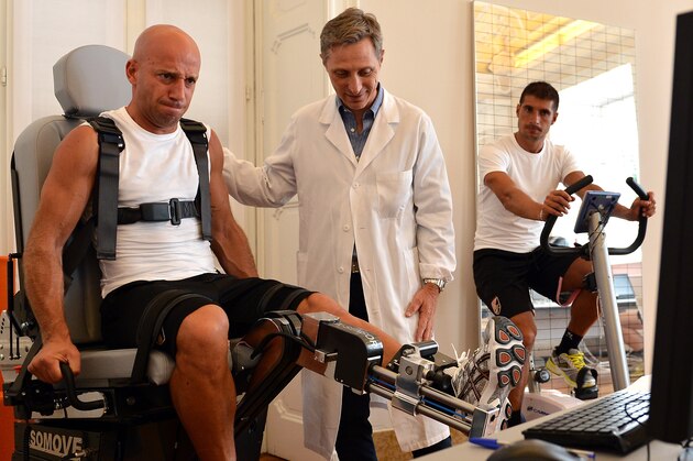 VARESE, ITALY - JULY 12:  Giulio Migliaccio (L) and Franco Brienza (R) in action as Doctor Ferdinando Battistella (R), Chief of US Citta di Palermo Medical Staf, looks on during a US Citta di Palermo medical test in the Human Performance Lab at La Quiete Clinic on July 12, 2012 in Varese, Italy.  (Photo by Tullio M. Puglia/Getty Images)