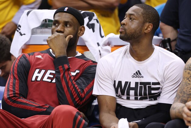 May 28, 2014; Indianapolis, IN, USA; Miami Heat forward LeBron James (left) and Miami Heat guard Dwyane Wade (right) sit on the bench during the fourth quarter in game five against the Indiana Pacers of the Eastern Conference Finals of the 2014 NBA Playoffs at Bankers Life Fieldhouse.  Indiana defeats Miami 93-90. Mandatory Credit: Brian Spurlock-USA TODAY Sports