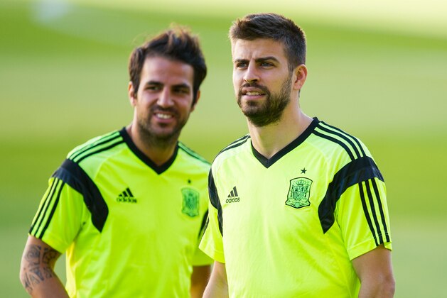 SEVILLE, SPAIN - MAY 29:  Cesc Fabregas (L) and Gerard Pique of Spain look on during a training session ahead of their international friendly match against Bolivia at the Ramon Sanchez Pizjuan stadium on May 29, 2014 in Seville, Spain.  (Photo by David Ramos/Getty Images)