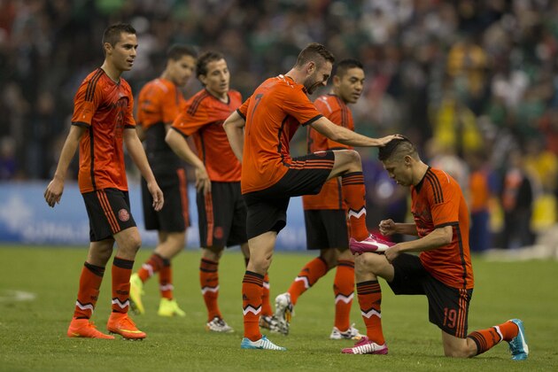 Mexicol's Miguel Layun celebrates with teammates after scoring during a friendly soccer match against Israel, in Mexico City, Wednesday, May 28, 2014. (AP Photo/Eduardo Verdugo)