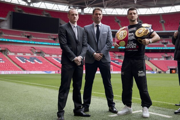 IBF and WBA super-middleweight boxing champion Carl Froch, right, poses for photographers with his opponent George Groves, left, and British boxing promoter Eddie Hearn at Wembley Stadium in London, Thursday, May 29, 2014.  Billed as one of the biggest fights in British boxing history, the second installment of Carl Froch vs. George Groves has the ingredients of a classic. Saturday's fight for Froch's IBF and WBA super-middleweight titles will take place at Wembley Stadium in front of a record British boxing crowd of about 80,000 fans.  (AP Photo/Matt Dunham)
