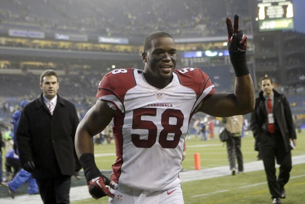 FILe - In this Dec. 22, 2013 file photo, Arizona Cardinals inside linebacker Daryl Washington jogs off the field after the Cardinals beat the Seahawks 17-10 in an NFL football game, in Seattle.  A judge in Maricopa County Superior Court, on Wednesday, April 23, 2014, sentenced  Washington to a year of supervised probation for assaulting a former girlfriend who is the mother of his daughter.  (AP Photo/Stephen Brashear, File)