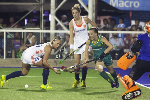 Netherlands' Jacky Schoenaker, left, challenges Australia's Emily Smith, right, during the women's field hockey World League final game, in San Miguel de Tucuman, Argentina, Sunday, Dec. 8, 2013.  (AP Photo/Paloma Cortes Ayusa)