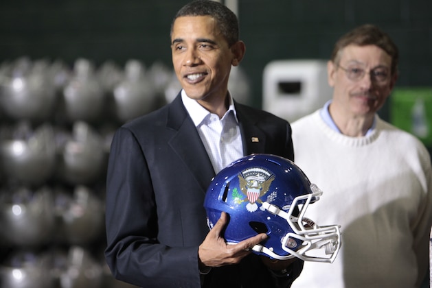 President Barack Obama stands with Ray Cromwell, vice president of sales operations, after he was presented with a personalized football helmet during a visit to the Riddell manufacturing facility, which makes sports equipment, Friday, Jan. 22, 2010, in Elyria, Ohio. (AP Photo/Charles Dharapak)