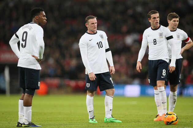 England's Daniel Sturridge, left, with teammates Wayne Rooney, second left, Jordan Henderson, and Steven Gerrard talk together before a free kick is taken during the international friendly soccer match between England and Denmark at Wembley stadium in London Wednesday, March 5, 2014. (AP Photo/Alastair Grant)