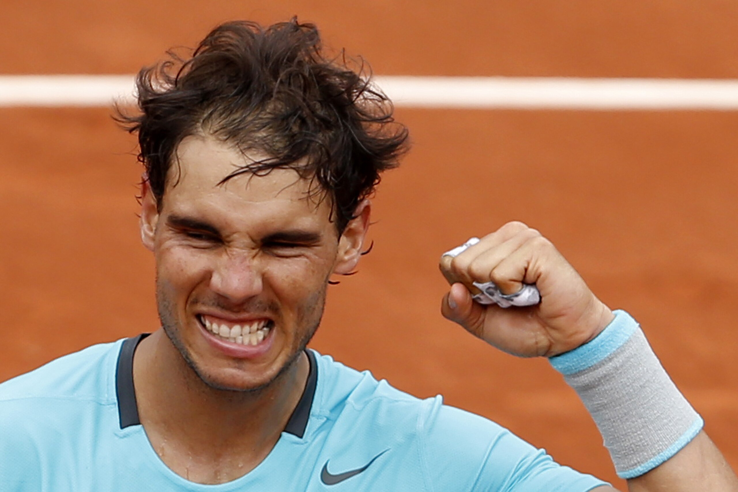 Spain's Rafael Nadal clenches his fist after defeating Austria's Dominic Thiem during the second round match of  the French Open tennis tournament at the Roland Garros stadium, in Paris, France, Thursday, May 29, 2014. Nadal won 6-2, 6-2, 6-3. (AP Photo/Darko Vojinovic)