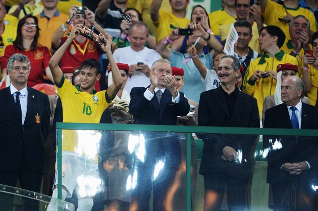 RIO DE JANEIRO, BRAZIL - JUNE 30:  Neymar of Brazil celebrates with the adidas Bronze Boot award as FIFA President Sepp Blatter (R) looks on after the FIFA Confederations Cup Brazil 2013 Final match between Brazil and Spain at Maracana on June 30, 2013 in Rio de Janeiro, Brazil.  (Photo by Michael Regan/Getty Images)