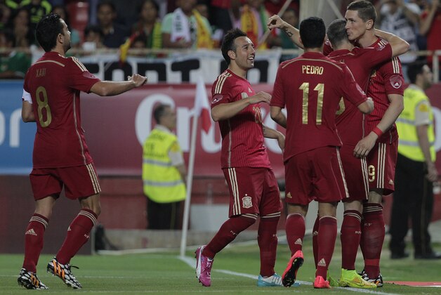Spain's Fernando Torres, right, celebrate with teammates after scoring against Bolivia during their friendly soccer match in Seville, on Friday, May 30. 2014. (AP Photo/Miguel Angel Morenatti)