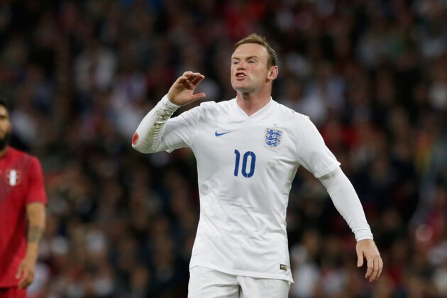 England's Wayne Rooney shouts instructions to a teammate during the international friendly soccer match between England and Peru at Wembley Stadium in London, Friday, May 30, 2014.  (AP Photo/Matt Dunham)