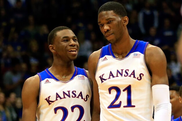 LAWRENCE, KS - NOVEMBER 22: Andrew Wiggins #22 of the Kansas Jayhawks talks with Joel Embiid #21 as they walk onto the floor after a timeout during the game against the Towson Tigers at Allen Fieldhouse on November 22, 2013 in Lawrence, Kansas. (Photo by Jamie Squire/Getty Images)