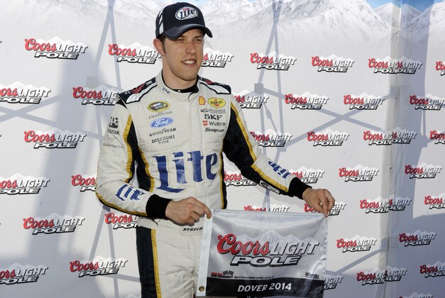 Brad Keselowski poses with the pole award after he took the pole for Sunday's NASCAR Sprint Cup series auto race, Friday, May 30, 2014, at Dover International Speedway in Dover, Del. (AP Photo/Nick Wass)