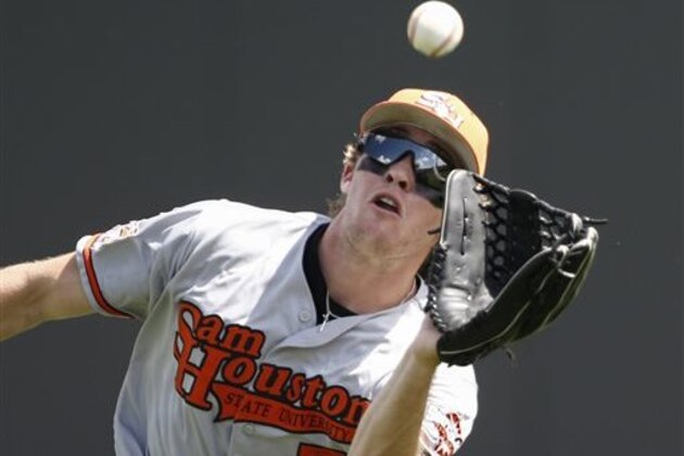 Sam Houston State outfielder Travis Lee catches a fly-out hit by Dallas Baptist's Austin Listi during the fourth inning of an NCAA college baseball regional tournament game in Fort Worth, Texas, Friday, May 30, 2014. (AP Photo/Jim Cowsert)