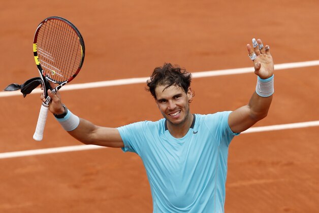 Spain's Rafael Nadal raises his arms after defeating Austria's Dominic Thiem during the second round match of  the French Open tennis tournament at the Roland Garros stadium, in Paris, France, Thursday, May 29, 2014. Nadal won 6-2, 6-2, 6-3. (AP Photo/Darko Vojinovic)