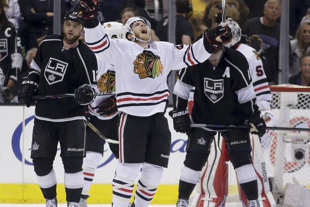 Chicago Blackhawks right wing Ben Smith, middle, celebrates as Los Angeles Kings right wing Marian Gaborik, left, and center Anze Kopitar look away after Game 6 of the Western Conference finals of the NHL hockey Stanley Cup playoffs in Los Angeles, Friday, May 30, 2014. The Blackhawks won 4-3. (AP Photo/Chris Carlson)