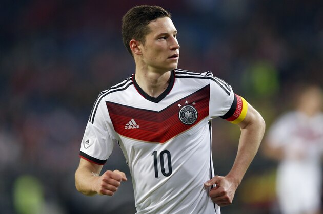 Germany's Julian Draxler watches his team mates during a friendly soccer match between Germany and Poland in Hamburg, Germany, Tuesday, May 13, 2014.  (AP Photo/Matthias Schrader)