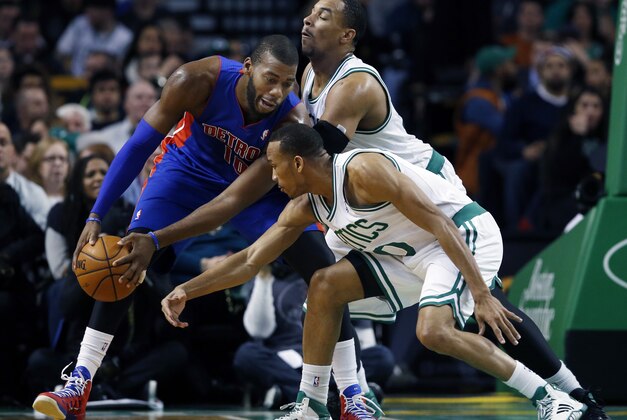 Detroit Pistons power forward Greg Monroe (10) looks to make a move against Boston Celtics forward Jared Sullinger and point guard Avery Bradley (0) in the second half of an NBA basketball game in Boston, Wednesday, Dec. 18, 2013. The Pistons won 107-106. (AP Photo/Elise Amendola)