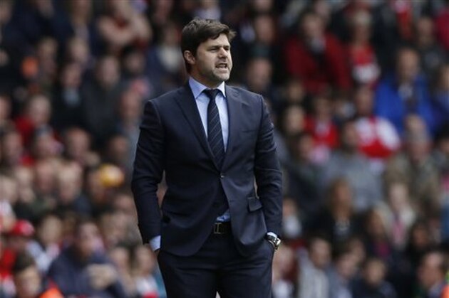 FILE - In this Sunday, May 11, 2014, file photo, Southampton's manager Mauricio Pochettino watches his team play against Manchester United during their English Premier League soccer match at St Mary's stadium, Southampton, England.  Tottenham has hired Mauricio Pochettino as the club's new manager on a five-year contract, with the former Argentina defender making the move from fellow Premier League side Southampton. (AP Photo/Sang Tan, File)