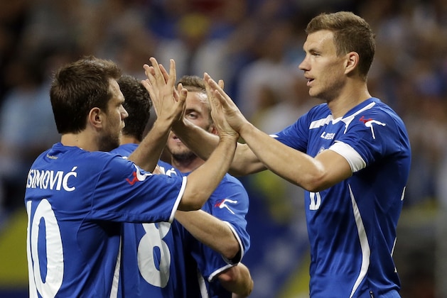 Bosnia-Herzegovina's Edin Dzeko, right, is congratulated by Zvjezdan Misimovic, left, after scoring during the second half in an international friendly soccer match against Ivory Coast on Friday, May 30, 2014, in St. Louis. Dzeko score both goals in the team's 2-1 victory. (AP Photo/Jeff Roberson)