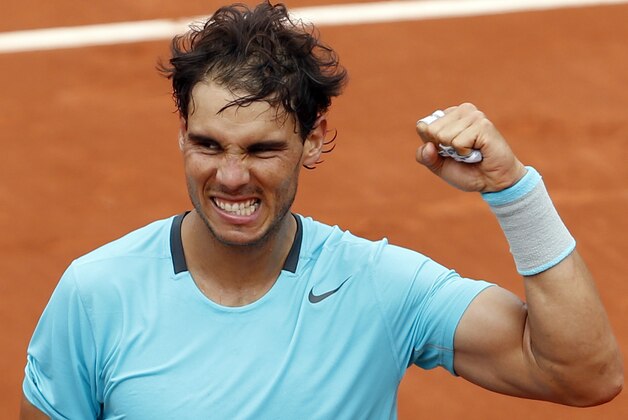 Spain's Rafael Nadal clenches his fist after defeating Austria's Dominic Thiem during the second round match of  the French Open tennis tournament at the Roland Garros stadium, in Paris, France, Thursday, May 29, 2014. Nadal won 6-2, 6-2, 6-3. (AP Photo/Darko Vojinovic)