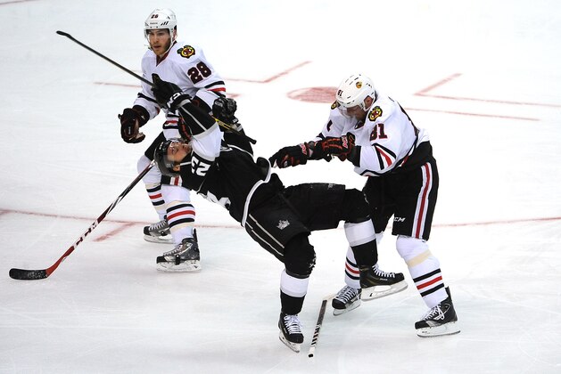 LOS ANGELES, CA - MAY 30: Marian Hossa #81 of the Chicago Blackhawks throws the check against Dustin Brown #23 of the Los Angeles Kings in Game Six of the Western Conference Final during the 2014 Stanley Cup Playoffs at Staples Center on May 30, 2014 in Los Angeles, California. (Photo by Noah Graham/NHLI via Getty Images)