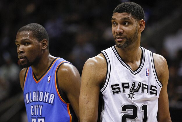May 29, 2014; San Antonio, TX, USA; Oklahoma City Thunder forward Kevin Durant (left) and San Antonio Spurs forward Tim Duncan (21) react during the second half in game five of the Western Conference Finals of the 2014 NBA Playoffs at AT&T Center. Mandatory Credit: Soobum Im-USA TODAY Sports
