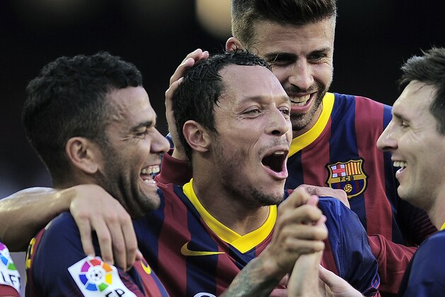 FC Barcelona's Daniel Alves, from Brazil, left, reacts after scoring with his teammates Adriano, from Brazil, second left, Gerard Pique, second right, and Lionel Messi, from Argentina, against Levante during a Spanish La Liga soccer match at the Camp Nou stadium in Barcelona, Spain, Sunday, Aug. 18, 2013. (AP Photo/Manu Fernandez)