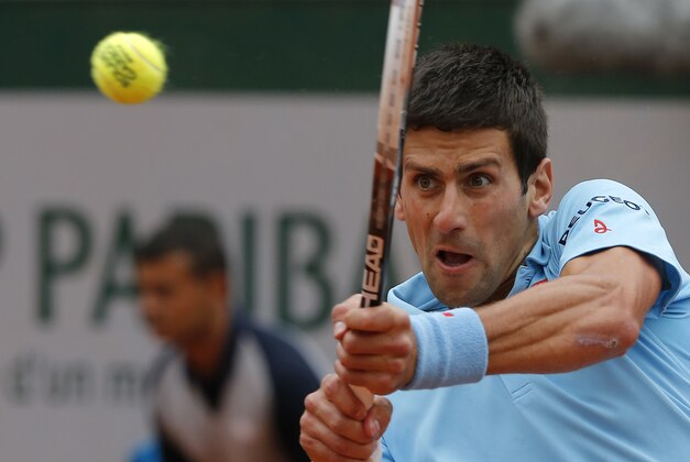 Serbia's Novak Djokovic returns the ball to Croatia's Marin Cilic during their third round match of  the French Open tennis tournament at the Roland Garros stadium, in Paris, France, Friday, May 30, 2014. (AP Photo/Michel Spingler)