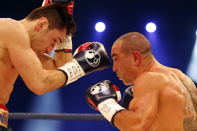 IBF Middleweight Champion Felix Sturm, left, punches his Australian challenger Sam Soliman during their IBF Middleweight title bout in Krefeld, Germany, Saturday, May 31, 2014.(AP Photo/Frank Augstein)