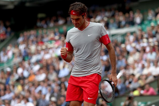 PARIS, FRANCE - MAY 30:  Roger Federer of Switzerland celebrates a point during his men's singles match against Dmitry Tursunov of Russia on day six of the French Open at Roland Garros on May 30, 2014 in Paris, France.  (Photo by Matthew Stockman/Getty Images)