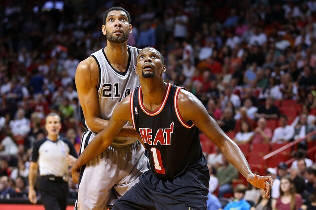 MIAMI, FL - JANUARY 26: Chris Bosh #1 of the Miami Heat boxes out Tim Duncan #21 of the San Antonio Spurs during a game  at American Airlines Arena on January 26, 2014 in Miami, Florida. NOTE TO USER: User expressly acknowledges and agrees that, by downloading and/or using this photograph, user is consenting to the terms and conditions of the Getty Images License Agreement. Mandatory copyright notice:  (Photo by Mike Ehrmann/Getty Images)