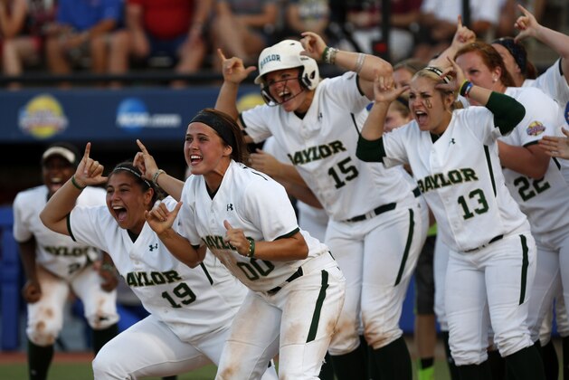 Baylor players react after Ari Hawkins hit a home run during an NCAA Women's College World Series softball tournament game against Kentucky in Oklahoma City, Saturday, May 31, 2014. (AP Photo/Garett Fisbeck)