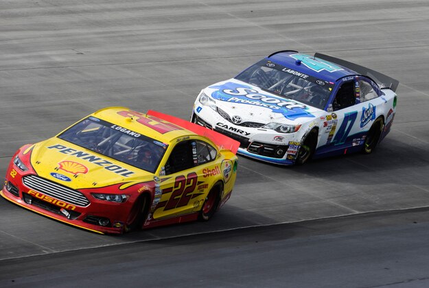 Jun 2, 2013; Dover, DE, USA; Sprint Cup Series driver Joey Logano (22) and driver Bobby Labonte (47) during the FedEx 400 Benefiting Autism Speaks at Dover International Speedway. Mandatory Credit: Jerome Miron-USA TODAY Sports