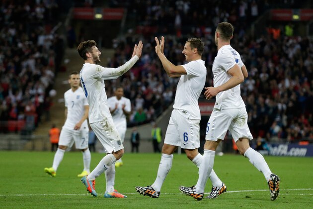 England's Phil Jagielka, center, celebrates his goal with Adam Lallana, left, and Gary Cahill during the international friendly soccer match between England and Peru at Wembley Stadium in London, Friday, May 30, 2014.  (AP Photo/Matt Dunham)