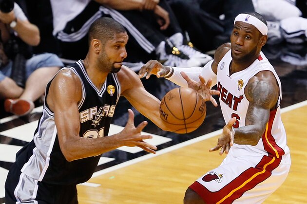 MIAMI, FL - JUNE 20:  Tim Duncan #21 of the San Antonio Spurs with the ball against LeBron James #6 of the Miami Heat in the first half during Game Seven of the 2013 NBA Finals at AmericanAirlines Arena on June 20, 2013 in Miami, Florida. NOTE TO USER: User expressly acknowledges and agrees that, by downloading and or using this photograph, User is consenting to the terms and conditions of the Getty Images License Agreement.  (Photo by Kevin C. Cox/Getty Images)