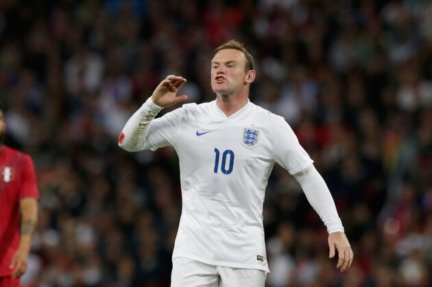 England's Wayne Rooney shouts instructions to a teammate during the international friendly soccer match between England and Peru at Wembley Stadium in London, Friday, May 30, 2014.  (AP Photo/Matt Dunham)